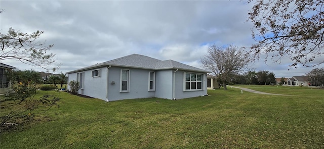 view of side of home featuring a yard