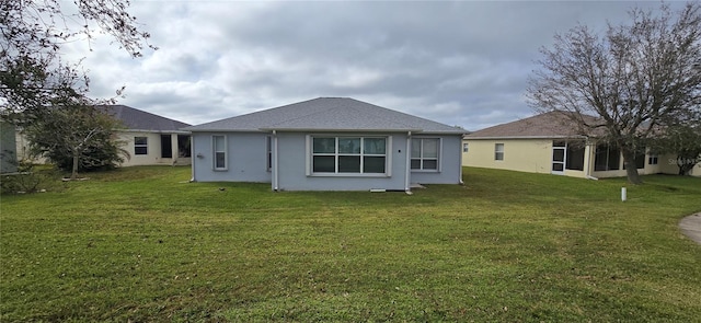 rear view of house with a yard