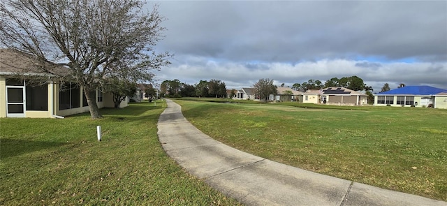 view of home's community with a yard