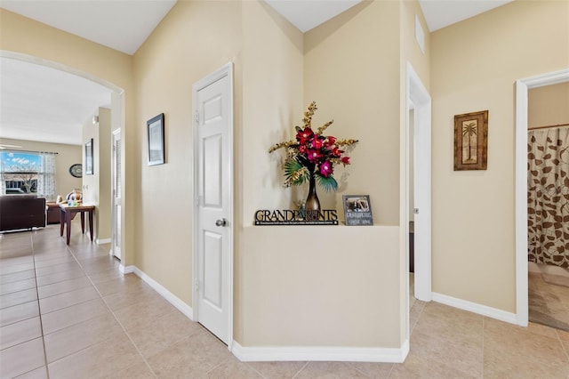 hall featuring light tile patterned flooring