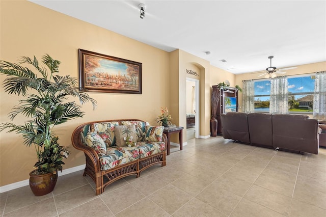 living room with ceiling fan and light tile patterned floors