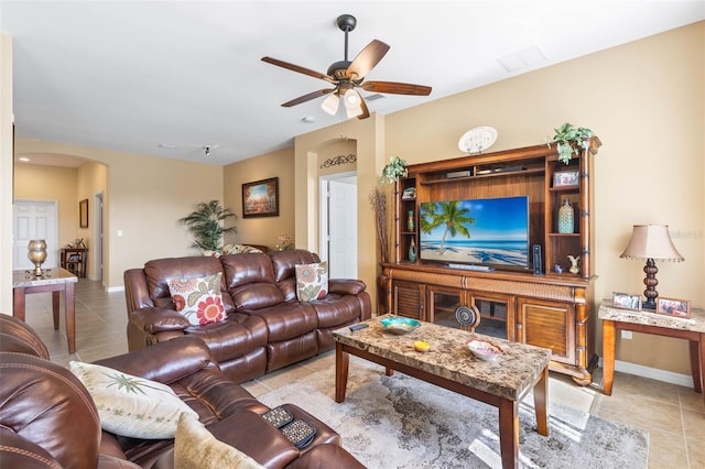 tiled living room with ceiling fan