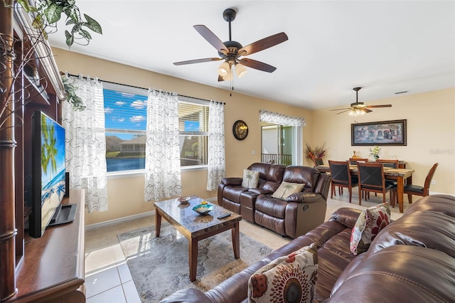 living room with ceiling fan and light tile patterned floors