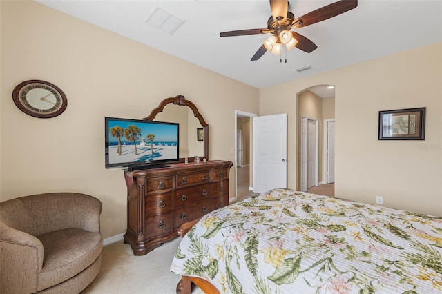 bedroom with ceiling fan and light carpet