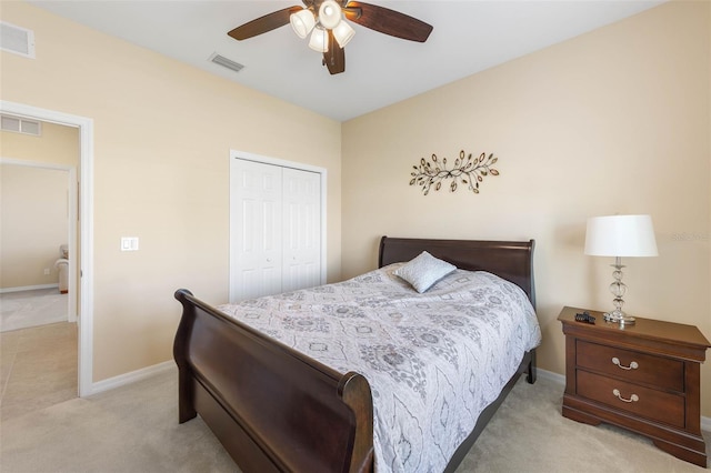 carpeted bedroom featuring a closet and ceiling fan