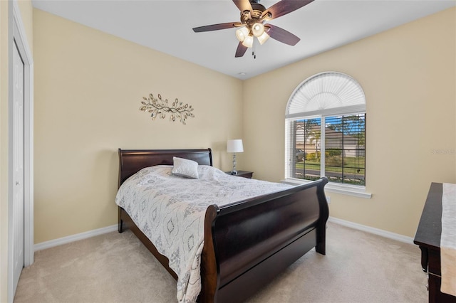 carpeted bedroom with a closet and ceiling fan