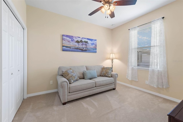 carpeted living room with ceiling fan