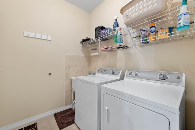 clothes washing area with tile patterned floors and washing machine and clothes dryer