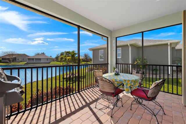 sunroom / solarium with a water view