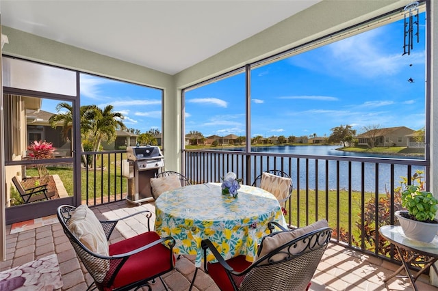 sunroom / solarium with a water view