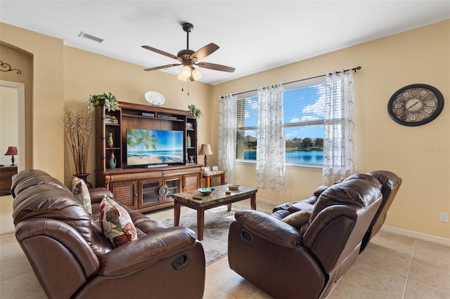 living room featuring light tile patterned flooring and ceiling fan