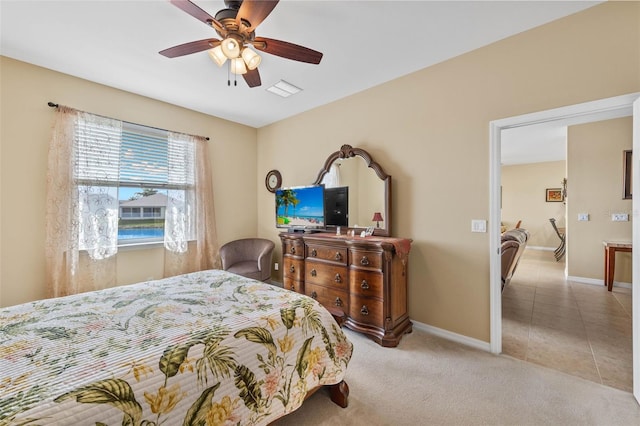 bedroom with light carpet and ceiling fan