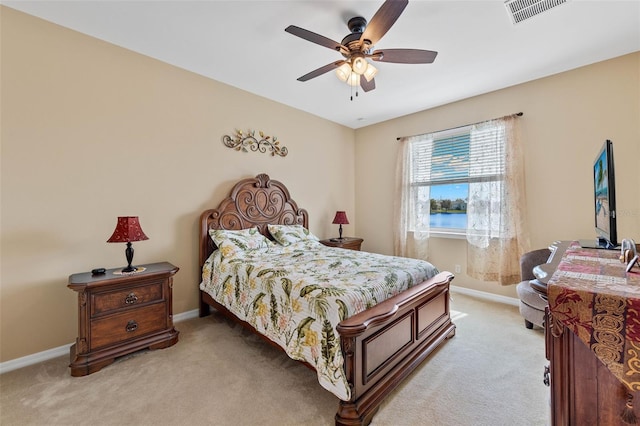 bedroom with ceiling fan and light carpet