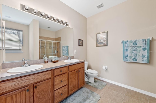 bathroom with an enclosed shower, vanity, tile patterned floors, and toilet