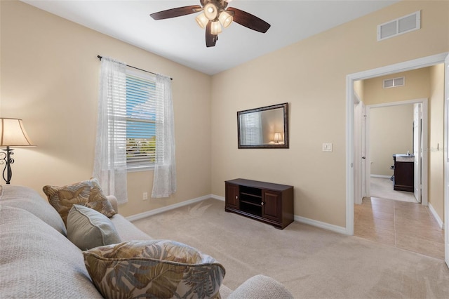 carpeted living room with ceiling fan