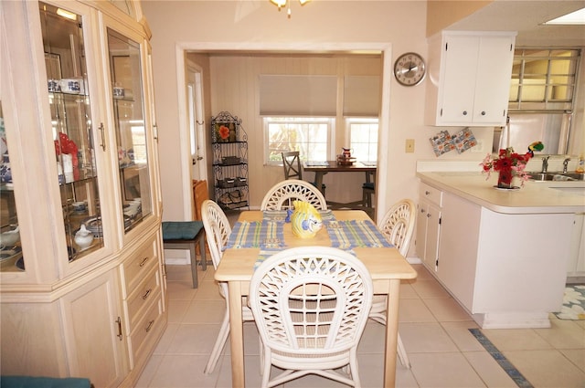 dining area with light tile patterned flooring and sink