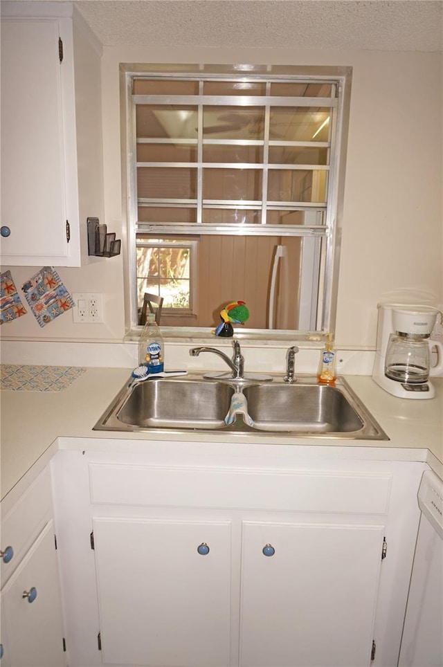 4158 Tamiami Trl Unit P1, Port Charlotte, FL 33952 - kitchen with light countertops, white cabinets, and a sink