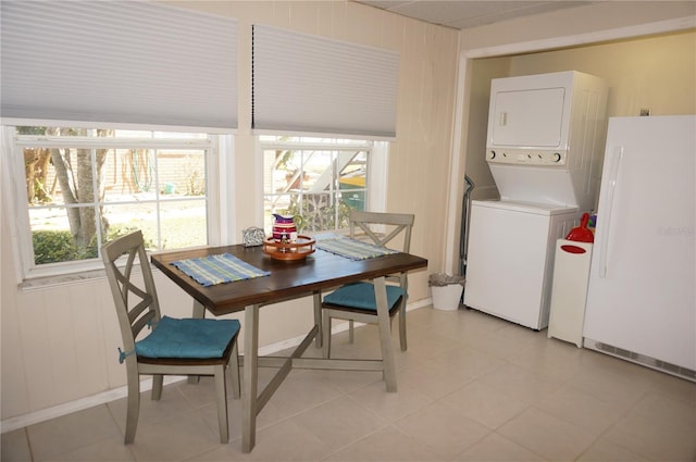 dining room with stacked washing maching and dryer and a healthy amount of sunlight