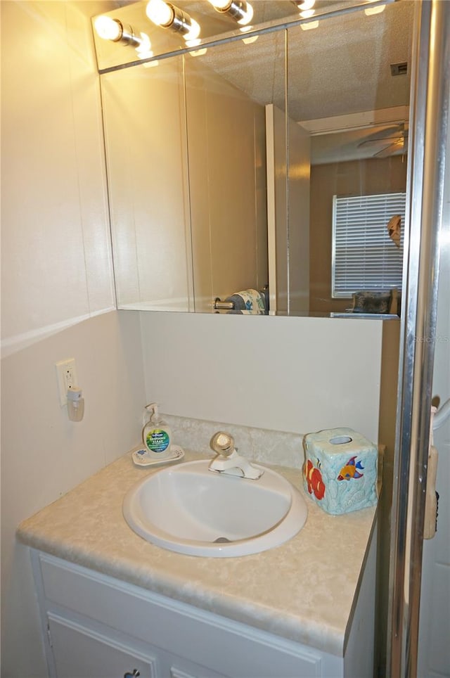 bathroom with vanity and a textured ceiling