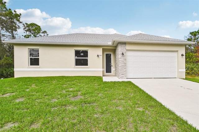 view of front of home featuring a garage and a front lawn