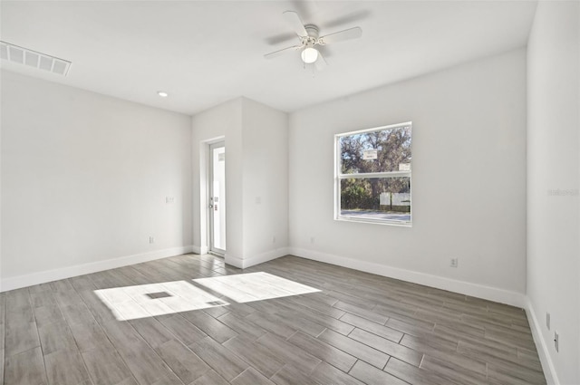 empty room featuring ceiling fan and light wood-type flooring