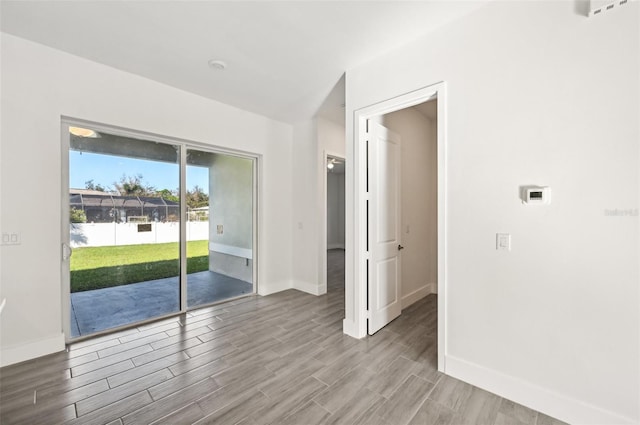 empty room with hardwood / wood-style flooring