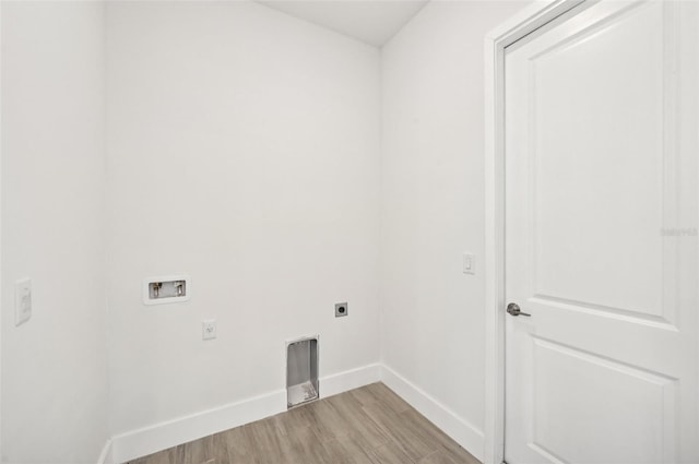 laundry area with hookup for a washing machine, hookup for an electric dryer, and light wood-type flooring