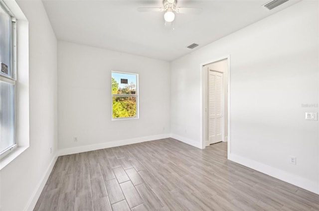 unfurnished room featuring light wood-type flooring and ceiling fan