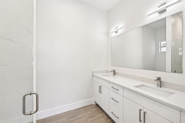 bathroom with vanity, hardwood / wood-style floors, and walk in shower