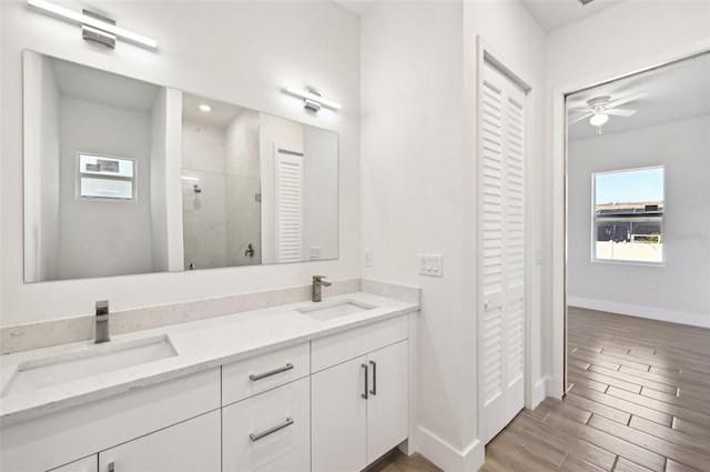 bathroom with vanity, walk in shower, wood-type flooring, and ceiling fan