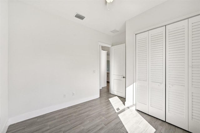 unfurnished bedroom featuring a closet and light hardwood / wood-style floors