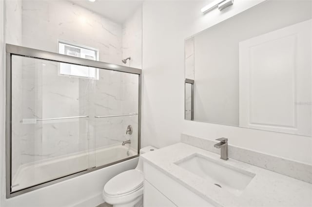 full bathroom featuring vanity, toilet, and combined bath / shower with glass door