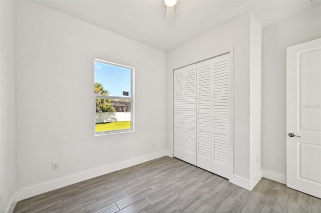 unfurnished bedroom featuring a closet, ceiling fan, and light hardwood / wood-style flooring