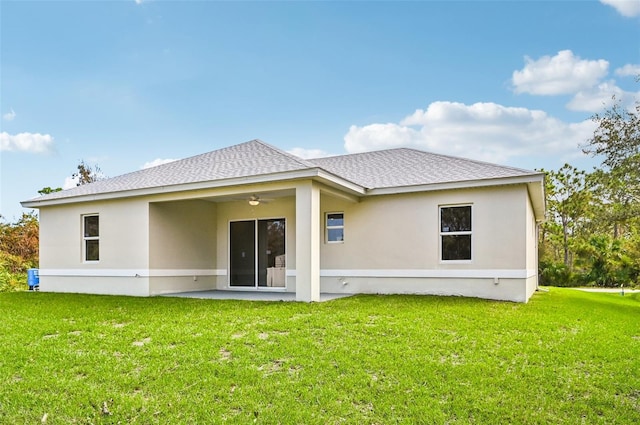 rear view of property featuring a patio area, a lawn, and ceiling fan