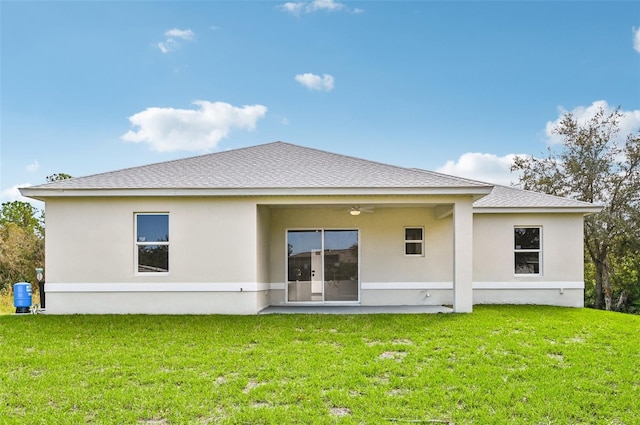 back of house featuring a patio area, a lawn, and ceiling fan