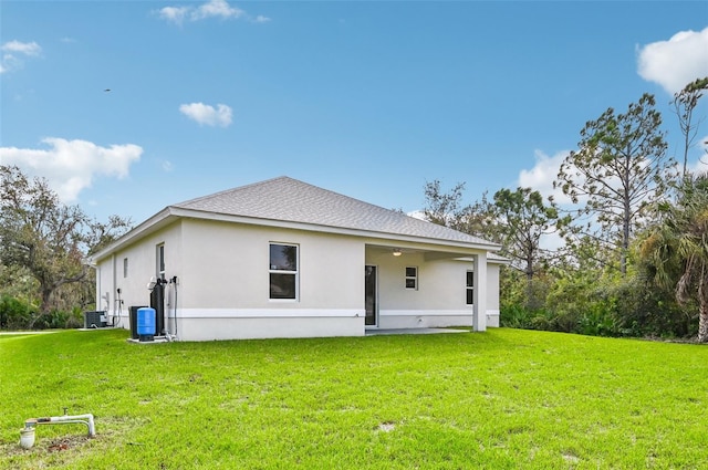 back of property featuring a lawn