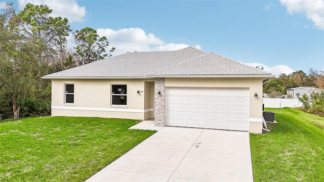 view of front facade with a front yard and a garage