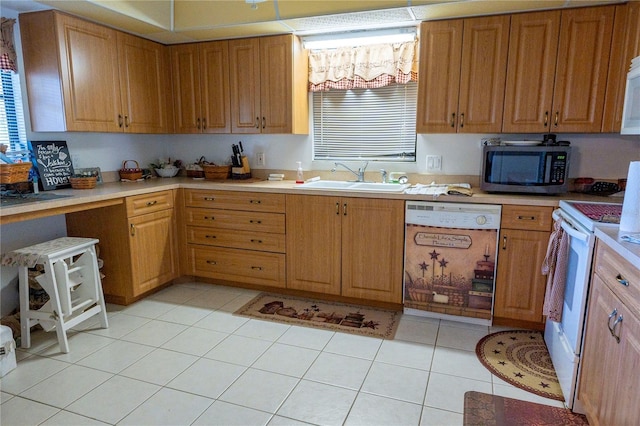 kitchen with sink, light tile patterned flooring, and white appliances