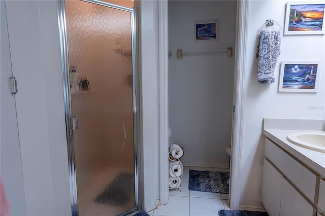 bathroom featuring vanity, tile patterned floors, and a shower with shower door