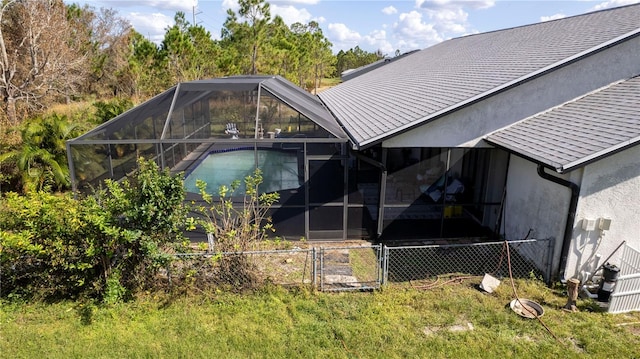 rear view of property with glass enclosure