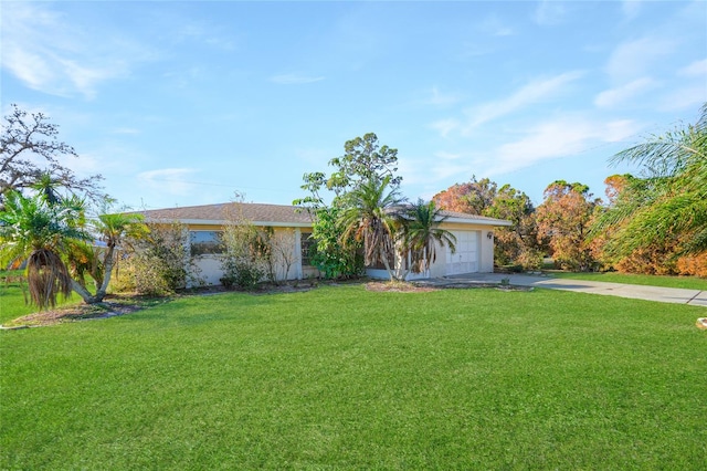 ranch-style home with a garage and a front lawn