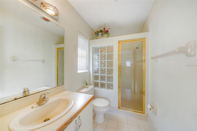 bathroom featuring vanity, an enclosed shower, toilet, and tile patterned flooring