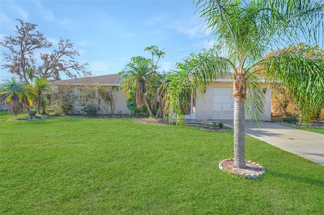 single story home with a front lawn and a garage