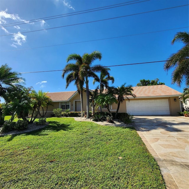 single story home featuring a garage and a front lawn