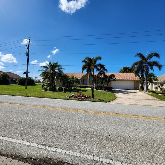 view of front of property with a front yard and a garage