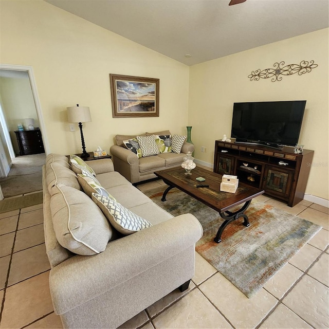 living room with tile patterned floors and lofted ceiling