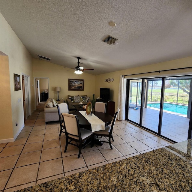 dining room featuring ceiling fan, a textured ceiling, and light tile patterned flooring