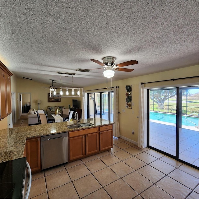 kitchen with dishwasher, sink, decorative light fixtures, and a textured ceiling