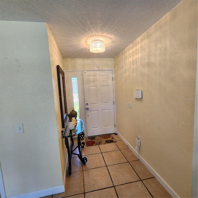 entryway featuring a textured ceiling and light tile patterned flooring