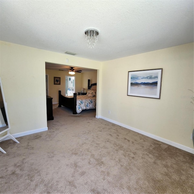 unfurnished bedroom with carpet and a textured ceiling